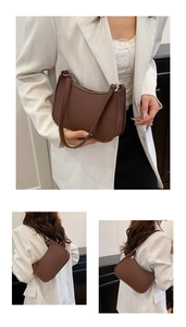 Brown faux leather crescent bag with litchi texture shown on a stylish model