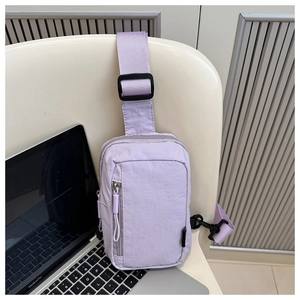 Detailed view of lavender nylon crossbody bag with vertical zipper and adjustable strap