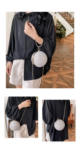 Detailed shot of spherical evening bag featuring silver glitter and metal ring handle