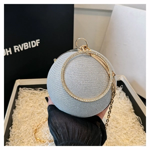 Close-up of spherical evening bag with rhinestones on circular metal handle