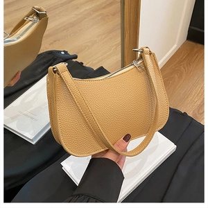 Detail of light khaki lychee pattern leather shoulder bag with smooth metal zipper