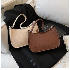 Detail of minimalist hobo bags featuring premium lychee texture in cream and dark coffee