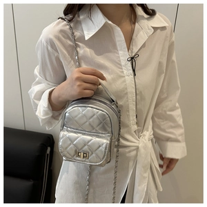 Silver quilted chain mini backpack worn by model showing modern chic style and fit
