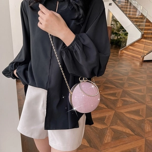 Pink glitter sphere evening bag with a crystal-embellished ring handle and gold chain strap