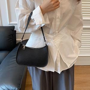 Minimalist black pebble leather hobo shoulder bag styled with a white shirt