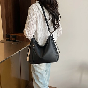 Black large capacity shoulder bag in matte PU leather shown on model back view
