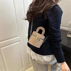 Fashionable light brown mini bucket bag with double zippers and gold chain strap