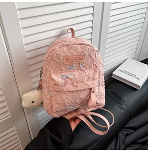 Pink quilted mini backpack with colorful bow beads and white plush cartoon charm detail