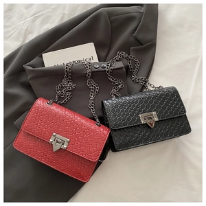 Close-up of woven texture flap bags in red and black with silver shield metal locks