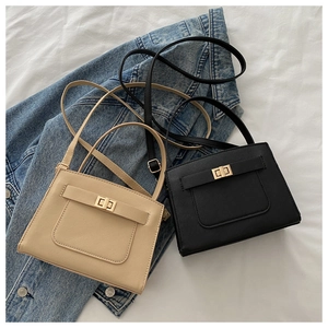 Detail of beige and black mini crossbody bags with metal twist lock and cross-grain texture