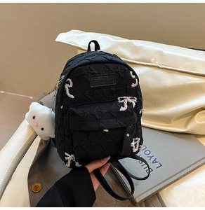 Black quilted mini backpack with embroidery, cloud plush charm and lettered brand tag