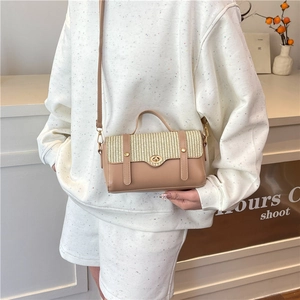 Contrast panel crossbody bag with woven straw flap and brown leather finish in studio
