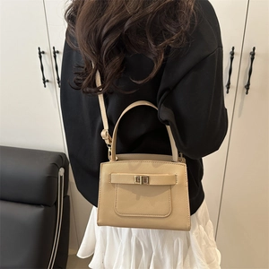Elegant apricot crossgrain leather crossbody bag with metal turn-lock and adjustable strap