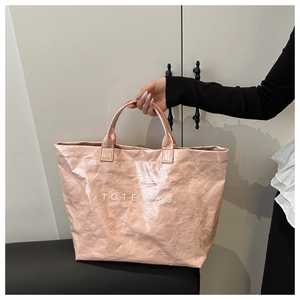 Detailed view of pink crinkle texture tote bag with white TOTE BAG text print