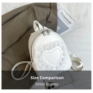 Size comparison of a white leather mini backpack featuring heart lace ruffle details
