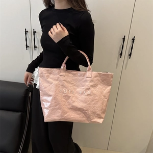 Stylish pink glossy DuPont paper tote bag shown with model for daily fashion commute
