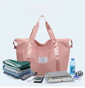 Pink large capacity travel bag showing organized space for clothes and accessories