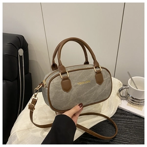 Detail of vintage grey textured Boston bag with brown leather handles and gold lettering