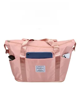 Pink waterproof nylon travel bag with front pocket for tablet and side storage