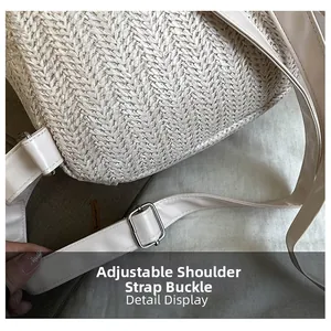 Detail display of the straw shoulder bag featuring an adjustable faux leather strap and metal buckle