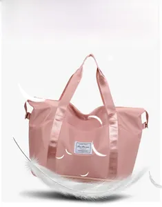 Close-up of pink nylon travel bag with waterproof fabric and bottom zipper compartment