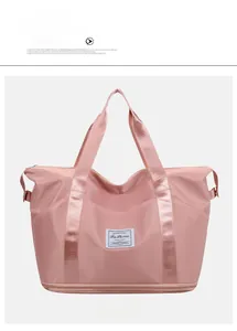 Detail of pink waterproof travel bag with reinforced straps and bottom expansion zipper