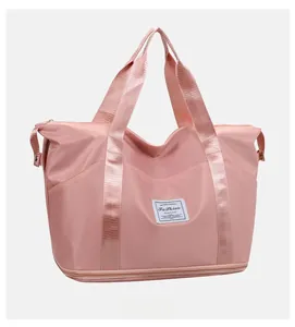 Macro detail of soft pink waterproof nylon travel bag with a separate bottom zip compartment