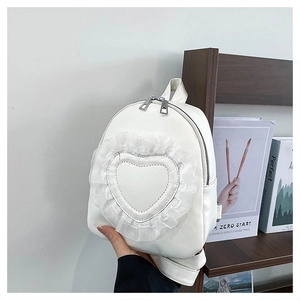 Detail of white mini backpack with heart-shaped lace ruffles and double metal zippers