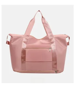 Pink waterproof travel bag showing the back luggage sleeve and hidden zipper pocket