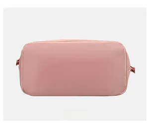 Detailed bottom view of pink expandable travel bag showing reinforced nylon seams