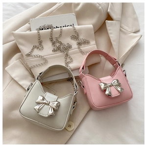 Detail of mini bags with silver bow buckles in pink and grey with chain straps