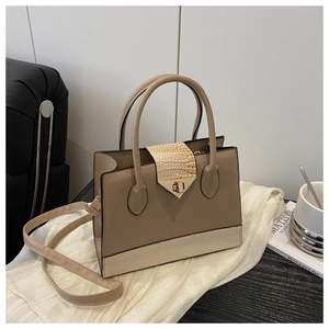 Detail of beige faux crocodile texture and gold square lock on minimalist handbag