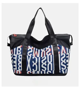 Close-up of waterproof nylon travel tote bag with red zippers and letter print patterns