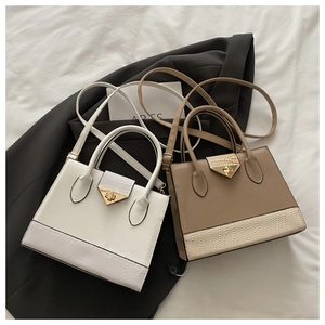Detailed view of fashion flap bags in white and khaki with gold triangle lock and crocodile texture