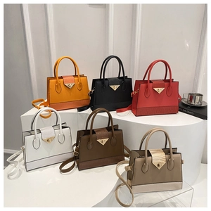 Group view of six colors of crossbody bags with crocodile texture and metal clasp