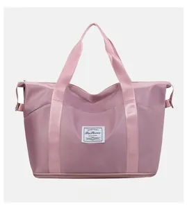 Front view of large capacity expandable travel bag in dusty rose waterproof nylon fabric