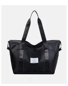 Front view of black waterproof nylon travel bag with large capacity and durable handles