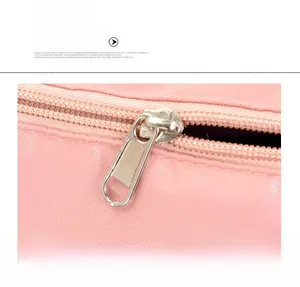 Close-up of smooth silver metal zipper and cross-textured pink fabric on travel bag