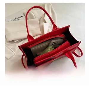 Interior view of red crocodile pattern tote bag showing large capacity and zipper pocket