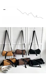 Cylindrical matte PU cross-body bags in yellow, brown and black with wide straps