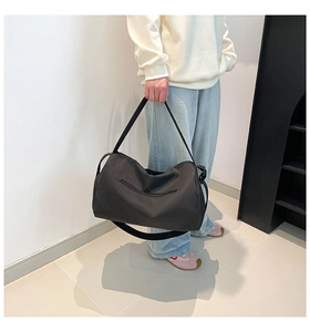Black lightweight nylon sports bag showing large capacity and side zipper detail for travel