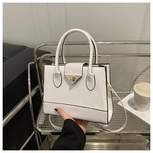 White faux leather tote bag with crocodile texture and gold triangle lock buckle