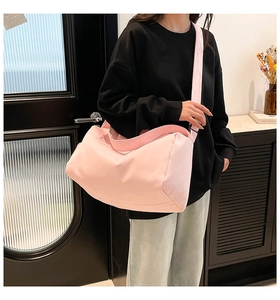 Detail of light pink large capacity crossbody yoga bag with adjustable wide shoulder strap