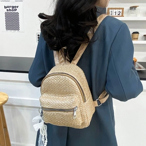 Women's trendy straw woven backpack with brown straps for summer beach leisure trips