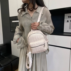 Women's cream straw backpack with V-shape woven texture and decorative pearl charm