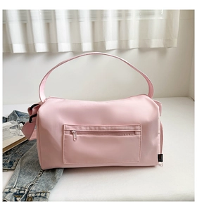 Detailed side view of pink fitness bag showing adjustable straps and waterproof nylon texture