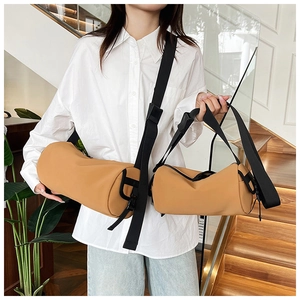 Brown frosted PU cylindrical bucket bags in large and small sizes shown on a model