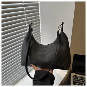Detailed close-up of a black crescent hobo bag with twill fabric and gold metal hooks