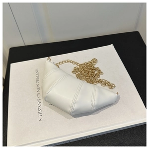 Detail shot of a white quilted crossbody croissant bag with elegant gold chain strap