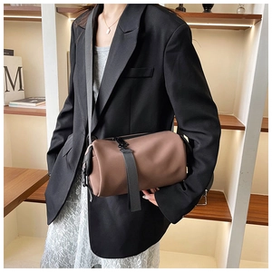 Minimalist matte PU cylinder crossbody bag in dark coffee with wide strap detail